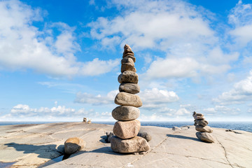 Fototapeta na wymiar Stacked Rocks balancing, stacking with precision. Stone tower on the shore. Copy space.