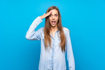 Young woman over isolated blue background has just realized something and has intending the solution