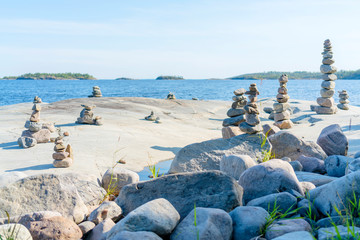 Stacked Rocks balancing, stacking with precision. Stone tower on the shore. Copy space.