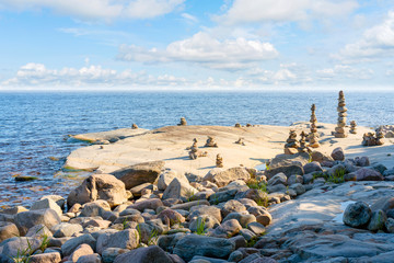 Stacked Rocks balancing, stacking with precision. Stone tower on the shore. Copy space.