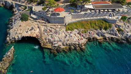 Aerial drone photo of beautiful turquoise rocky seascape of Hydroneta with picturesuqe windmill a...