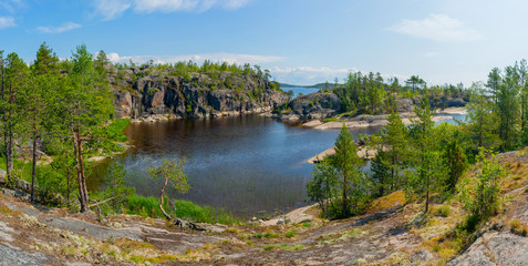 Fototapeta na wymiar Islands in Lake Ladoga. Beautiful landscape - water, pines and boulders.