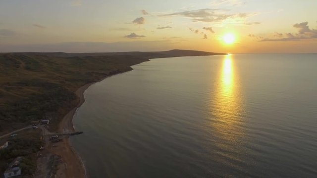 Sunset on sea. AERIAL: Landscape of sea coast at sunset  Sea ​​bay near island at sunset, aerial video
