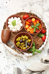 Mediterranean snack - mozzarella, olives,cherry tomatoes and basil leaves