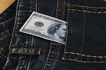 Banknote split out of a jean pocket .