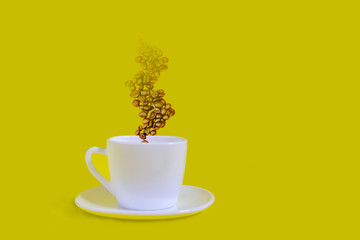 Coffee beans and white cups on a yellow background