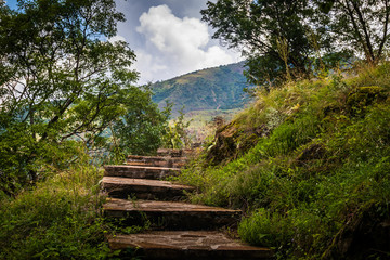 Mountain footpath through forest along the rocks. This is the path to the ruins of the medieval castle Maglic in Serbia.