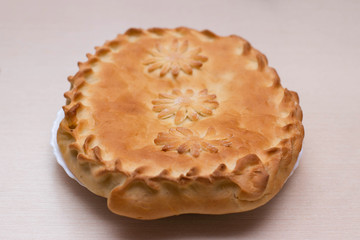 Ruddy beautiful homemade pie on the table