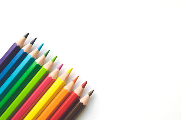 Rows of Color pencils on white paper background, copy space. Office supplies, back to school.