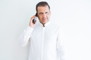 Middle age man calling using smartphone with a confident expression on smart face thinking serious