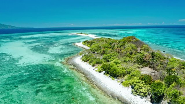 Truly amazing tropical island in the middle of the ocean. Aerial view of an island with white sand beaches and beautiful lagoons
