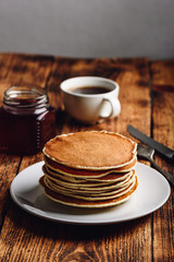 Stack of pancakes on white plate