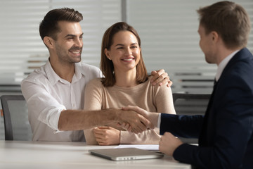 Happy young couple handshake lawyer insurer broker make business deal