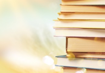 Stack of colorful books on blurred background