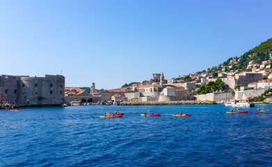 Fototapeta na wymiar Kayaking in the waters near Old Town Dubrovnik