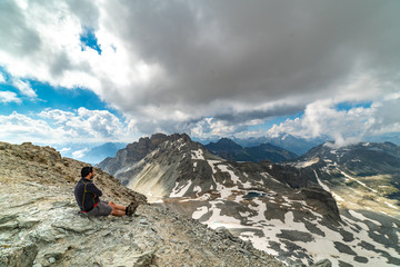 Fototapeta premium young hiker man looking on alps mountains, Panorama hike, concept of adventure and freedom