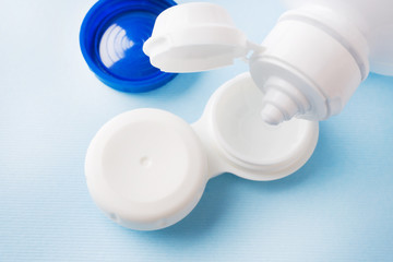 Contact lenses, solution bottle and lens storage container. Close up. Selective focus.