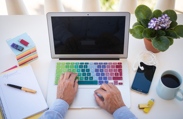 One senior people woman freelance works outdoor in the terrace. Two hands on the laptop. Cup of coffee. Alternative office. Cellphone and devices close to her