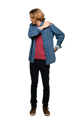 Full-length shot of Blonde man suffering from pain in shoulder for having made an effort over isolated white background