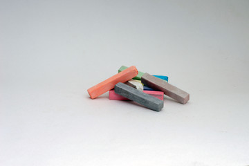 A few multicolored crayons lie chaotically.