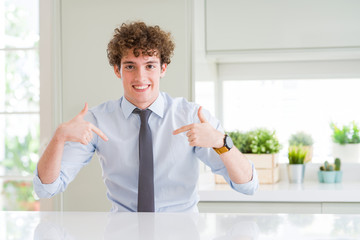 Young business man wearing a tie looking confident with smile on face, pointing oneself with fingers proud and happy.