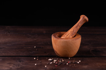 wooden mortar with pepper, low key, olive wood, rustic