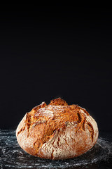 Bread background. Fresh bread on dark board. Close-up. Bakery concept. Rustic style
