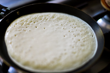 Macro close-up of pancake cooking in a pan