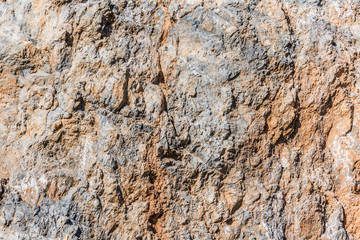 background and texture of mountain layers and cracks in sedimentary rock on cliff face. Cliff of rock mountain.