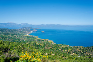Fototapeta na wymiar Top view from the mountains to the village of Malia, roads and the nearby villages of the field and the Aegean Sea. Crete, Greece