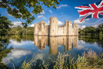 Historic Bodiam Castle with flag of England in East Sussex, United Kingdom