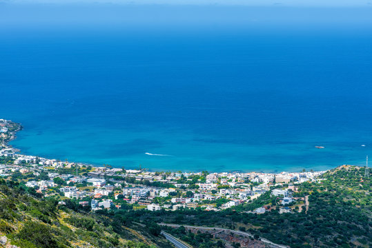 Top view from the mountains to the village of Malia, roads and the nearby villages of the field and the Aegean Sea. Crete, Greece