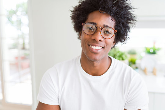 African American man wearing glasses with a happy and cool smile on face. Lucky person.