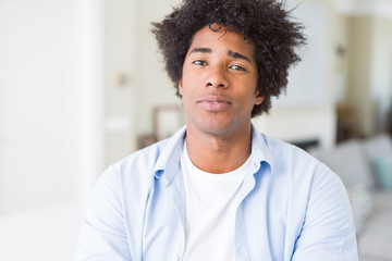 African American man at home Relaxed with serious expression on face. Simple and natural with crossed arms