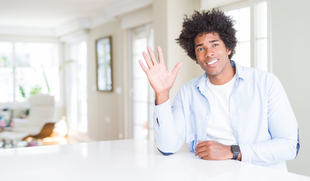 African American man at home showing and pointing up with fingers number five while smiling confident and happy.