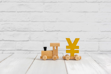 Golden yen sign on wood train over white background with copy space