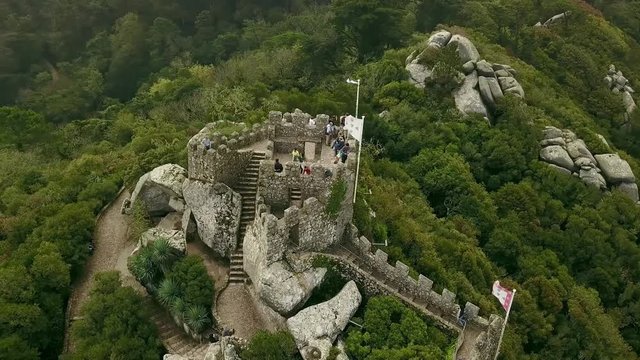 Aerial around view of Castelo dos Mouros or Moorish Castle, Moors in fog and clouds, Sintra, Portugal