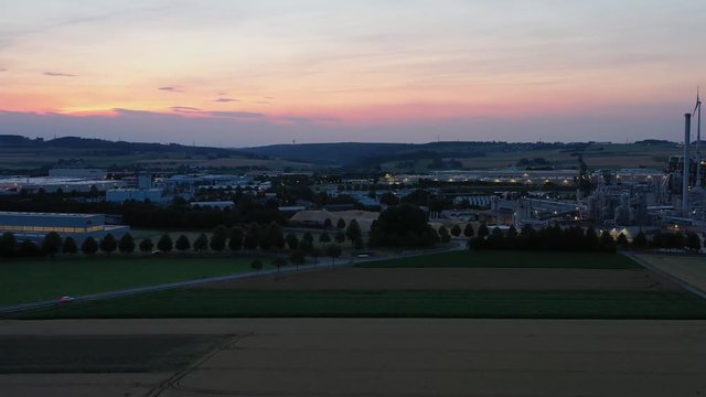 Southeastern aerial view of the Brilon industrial area at sunset. Landing with a view of several companies. Very detailed.