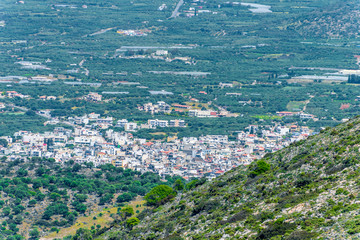 Top view from the mountains to the village of Malia, roads and the nearby villages of the field and the Aegean Sea. Crete, Greece
