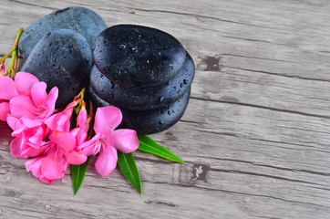 Obraz na płótnie Canvas Flower with zen stone on wood background
