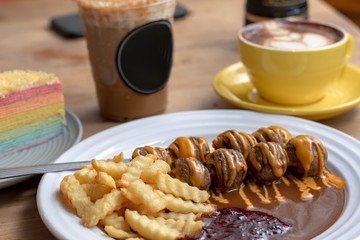 meatballs and french fries with brown sauce