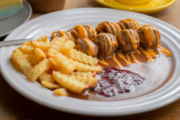 meatballs and french fries with brown sauce