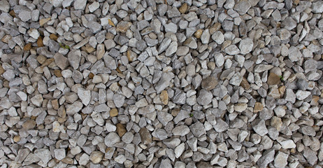 Construction breakstone background. Gravel road texture. The grey building rubble.