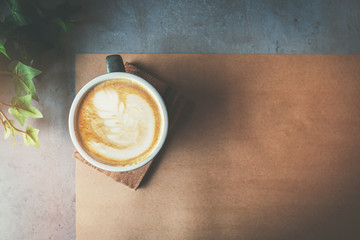 cup of cafe latte on the table. top view copy space