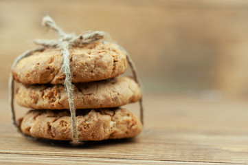 stack of cookies tied with a rope on a wooden background