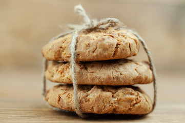 stack of cookies tied with a rope on a wooden background
