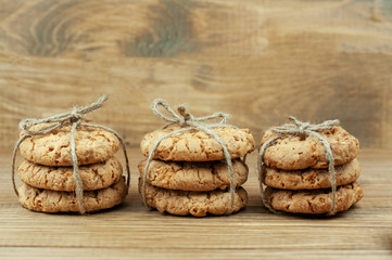 Fototapeta na wymiar stack of cookies tied with a rope on a wooden background