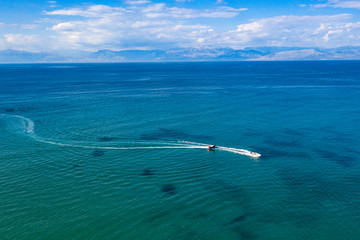 Aerial view of boats floating on calm sea water. Turquoise ocean seen from above.