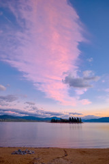 Lake Jindabyne sunrise and trail of glowing pink cloud, Australia