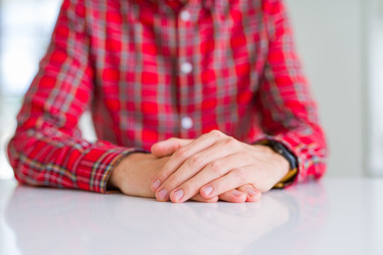 Close up of man hands with palms together over white table